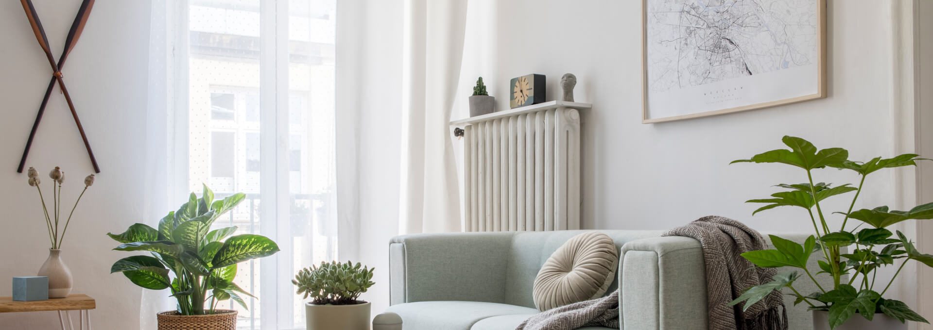 a living room with a couch, coffee table and plants at The  Hargrove at Southpoint