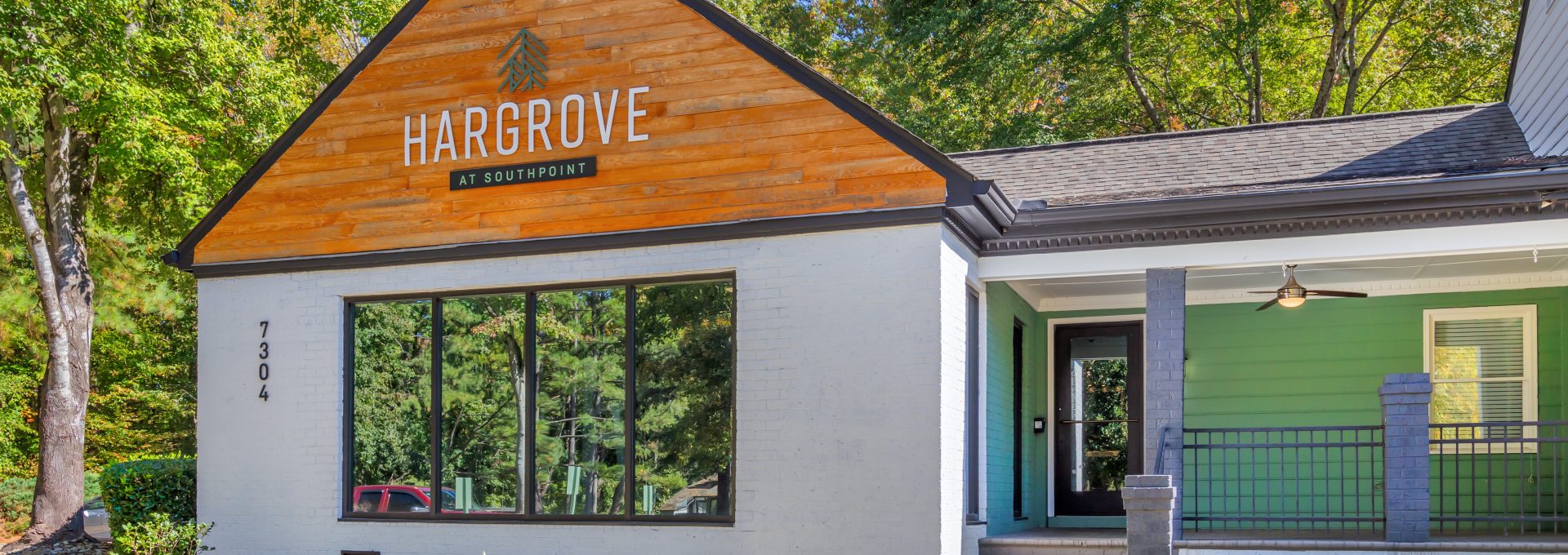 the front of a building with a sign that says, the barber shop at The  Hargrove at Southpoint